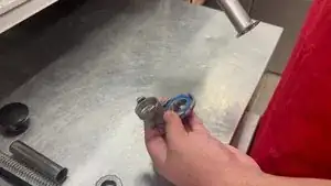 You start by screwing on the bottom to the main pipe