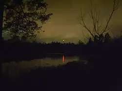 Филькино озеро осенней ночью. Огонёк — световое заграждение башни сотовой связи