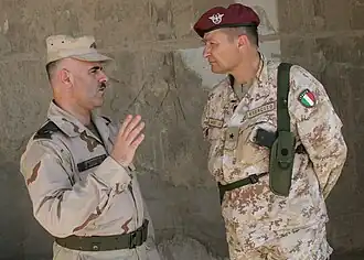 Итальянский бригадный генерал Антонио Сатта и командир азербайджанских миротворцев майор Эльхан Шалбузов обсуждают вопросы безопасности на охраняемом объекте.