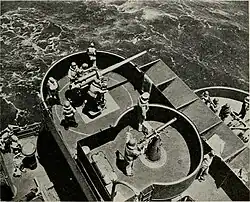 12,7-мм пулемёт Browning M2 водяного охлаждения рядом с&nbsp;артиллерийским орудием калибра 3"/50 на войсковом транспорте ВМС&nbsp;США; примерно 1943&nbsp;год.