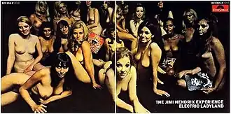 alt=A color photograph of a record sleeve featuring an image of several naked women