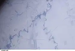 Вид на низовье Камелика (справа) около устья с борта МКС в декабре 2002 года