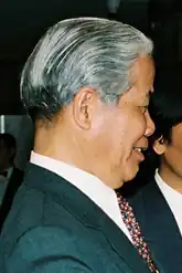 An old graying man wearing traditional clothing